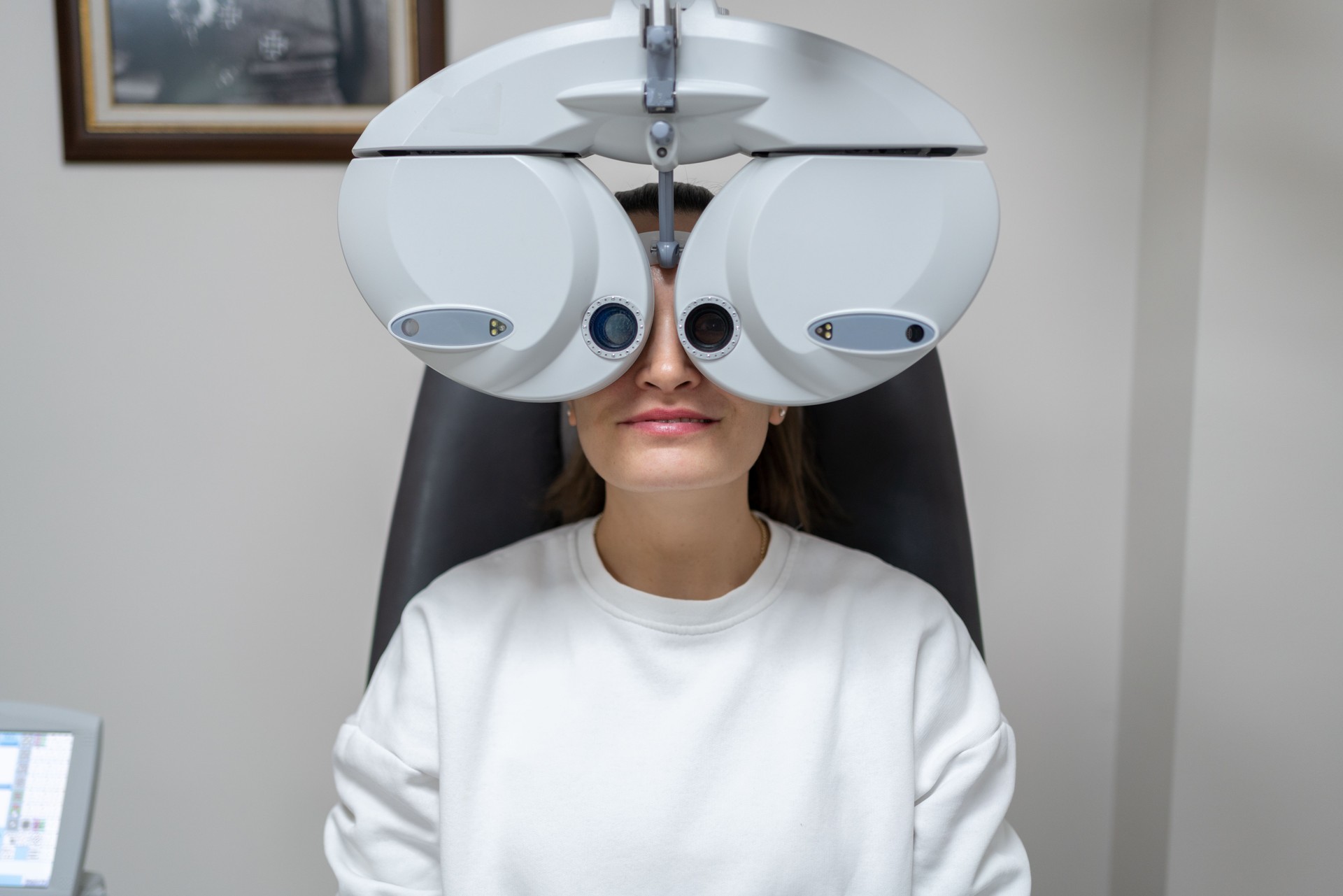 Doing Eye Test On Phoropter At Ophthalmology Clinic